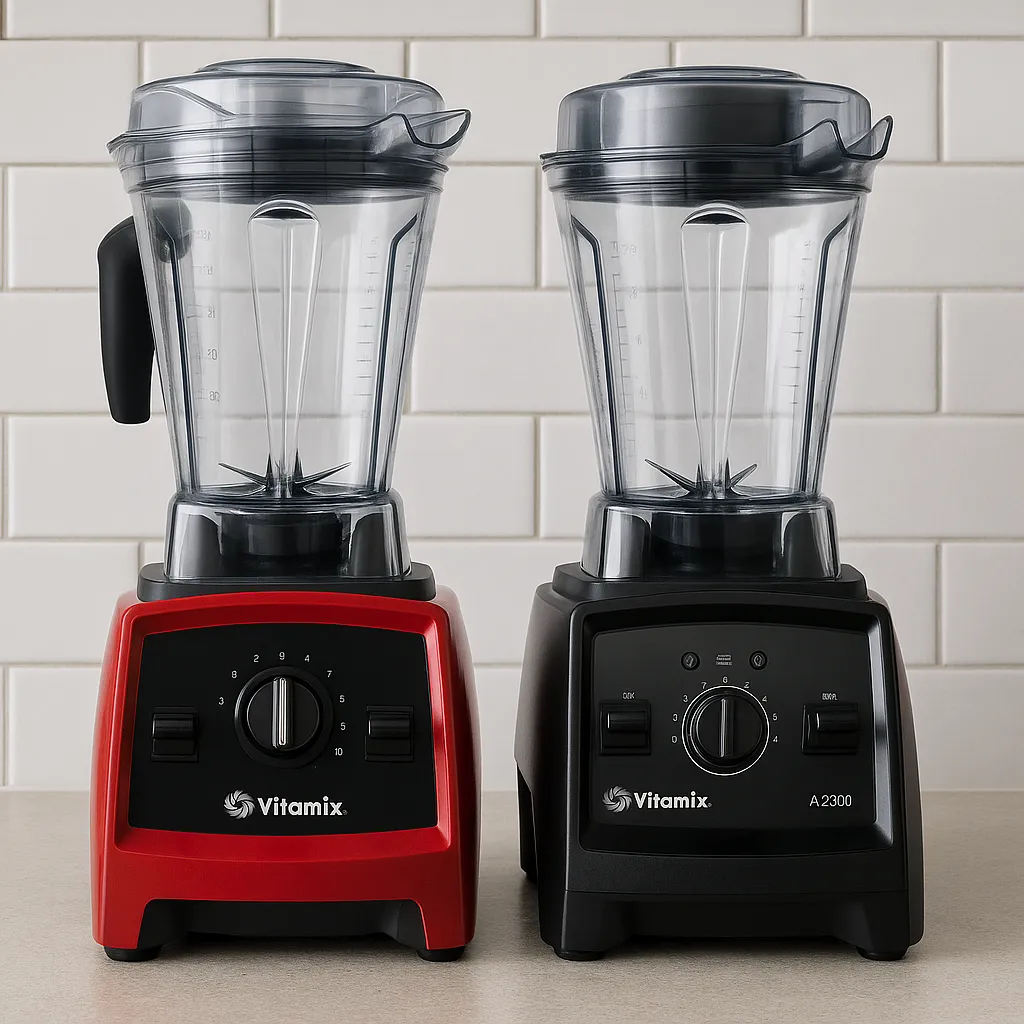 A red Vitamix A2300 and a black Vitamix A2500 blender side by side on a modern kitchen counter with a white tile backsplash.